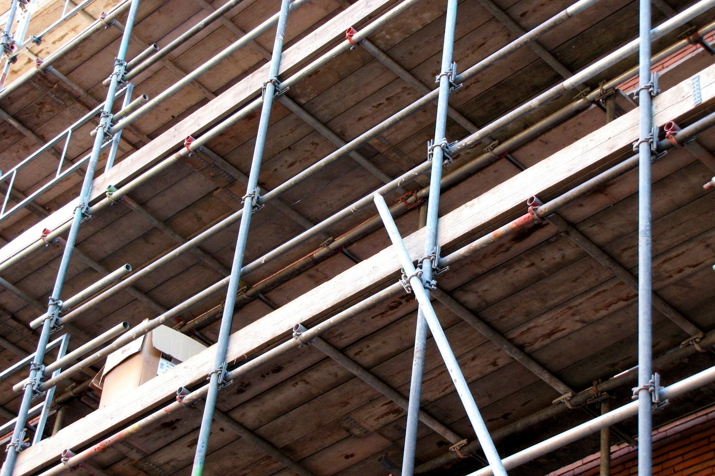 Scaffolding on the side of a building under construction, showing solid foundations and steady progress